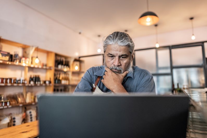 business owner working on computer preventing a data breach